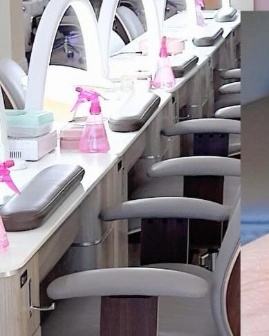 Inside Star Nails, with manicure stations and pink walls